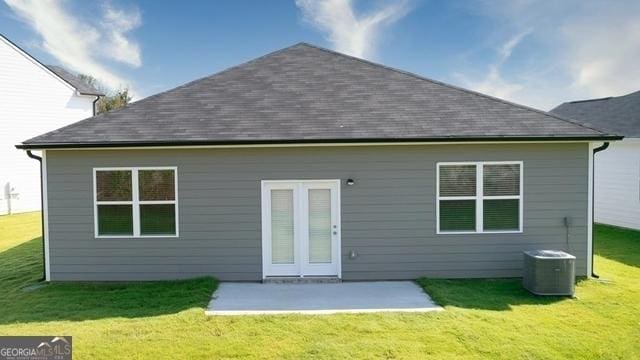 rear view of house with a lawn, central air condition unit, and a patio area