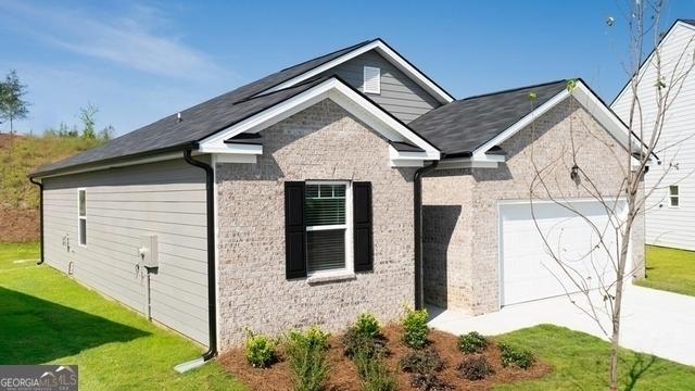 view of property exterior with a lawn and a garage