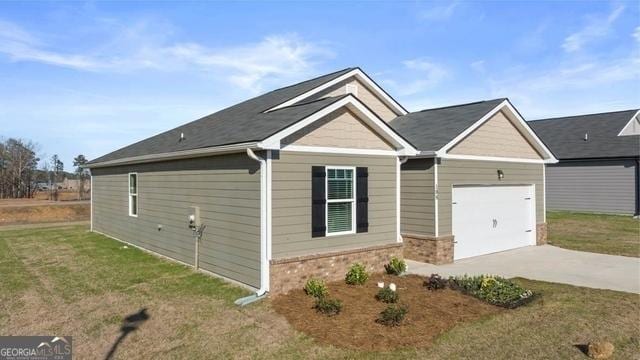 view of front of home with a front yard and a garage