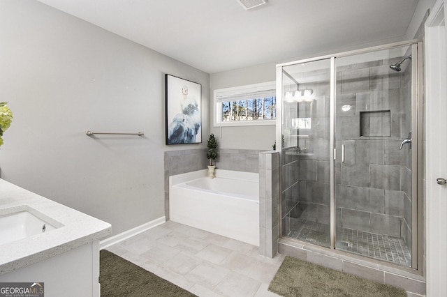 bathroom with tile patterned flooring, shower with separate bathtub, and vanity