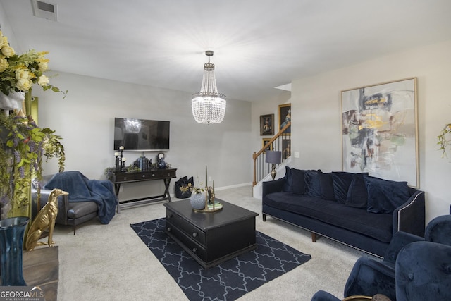 carpeted living room with a notable chandelier