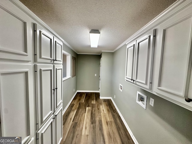 hallway with a textured ceiling, ornamental molding, and dark hardwood / wood-style floors