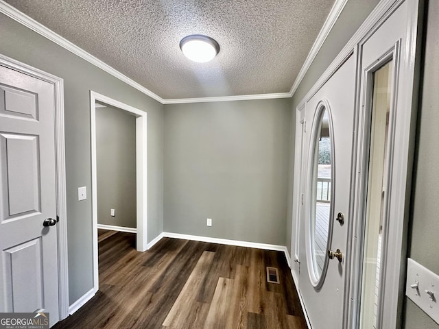 entryway with a textured ceiling, dark hardwood / wood-style flooring, and crown molding