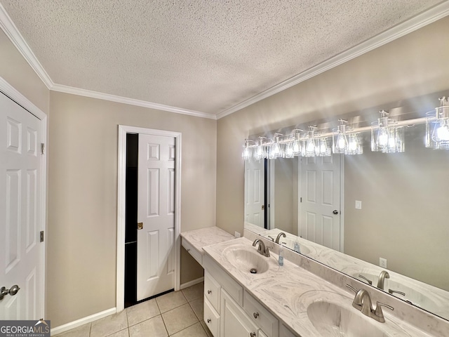 bathroom featuring tile patterned flooring, ornamental molding, a textured ceiling, and vanity