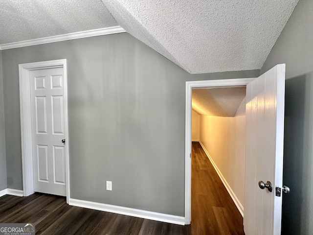 hallway featuring dark wood-type flooring, a textured ceiling, and ornamental molding