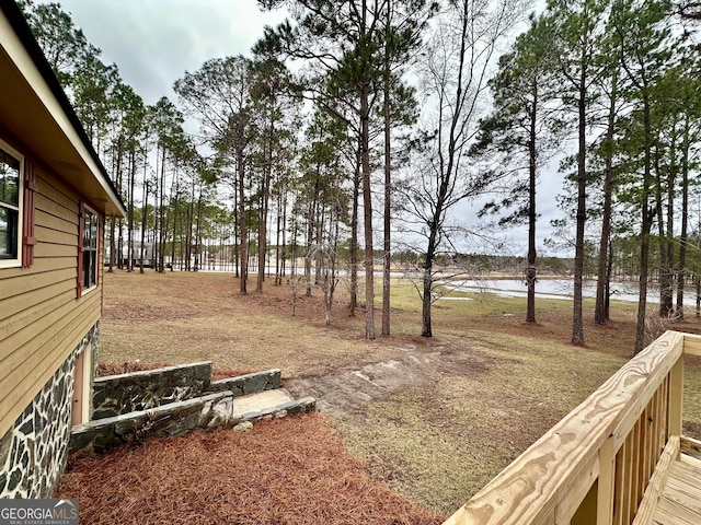 view of yard featuring a deck with water view