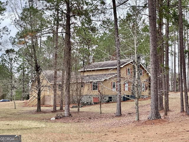 view of property exterior featuring a lawn