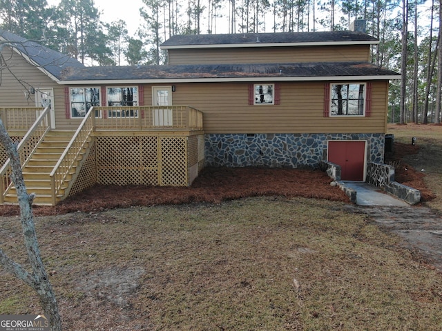 rear view of property featuring a deck