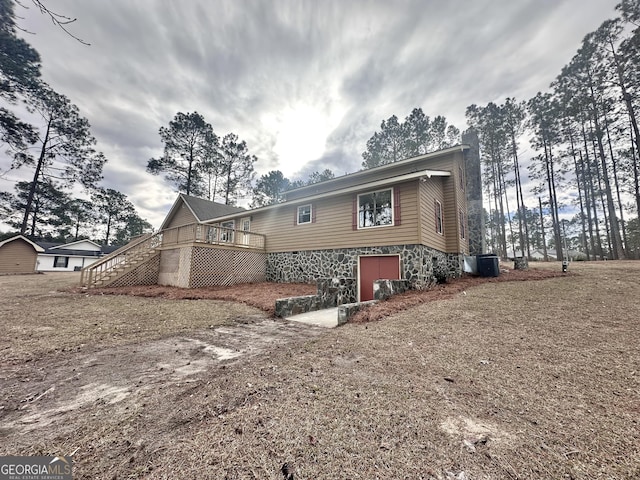 view of property exterior with a deck and cooling unit