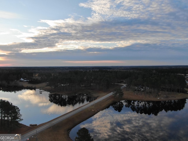 aerial view at dusk with a water view