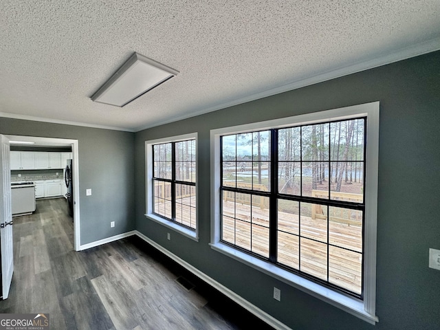 empty room with a textured ceiling and a healthy amount of sunlight