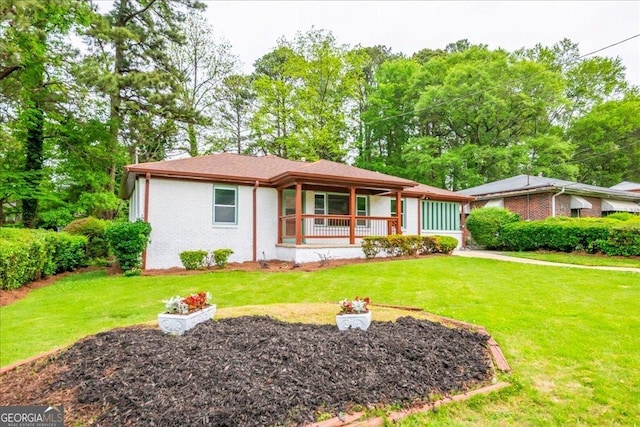 ranch-style house with a front yard and covered porch