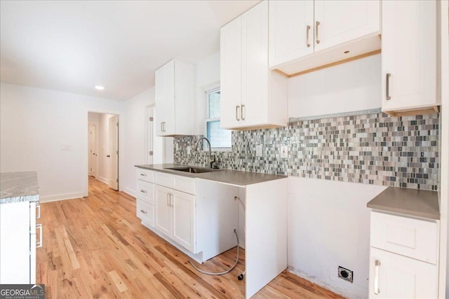 kitchen featuring light hardwood / wood-style floors, sink, and white cabinets