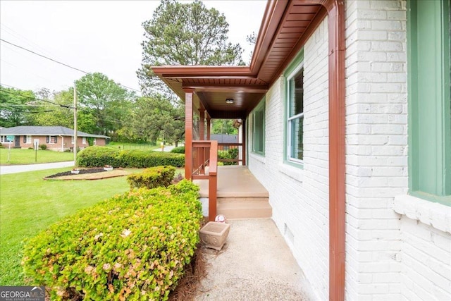 view of side of property featuring a porch and a lawn