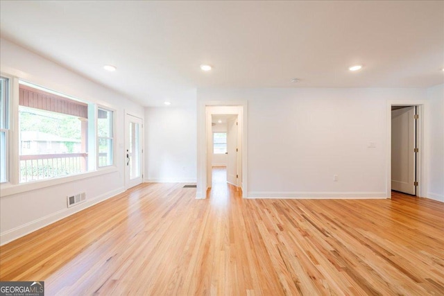 unfurnished room with light wood-type flooring