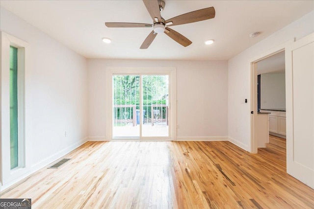 empty room with ceiling fan and light wood-type flooring