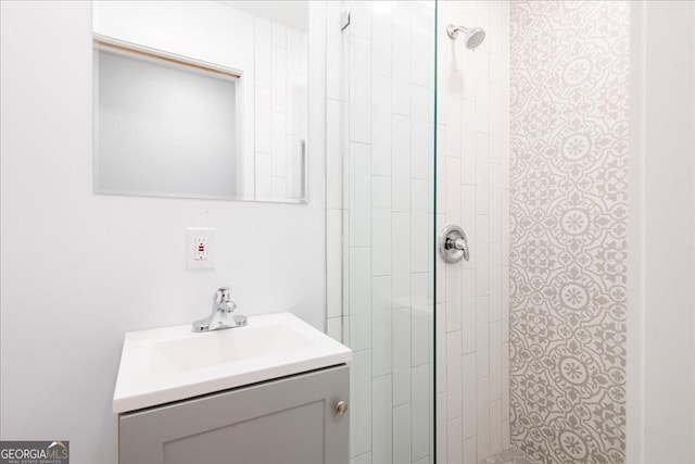 bathroom featuring vanity and tiled shower