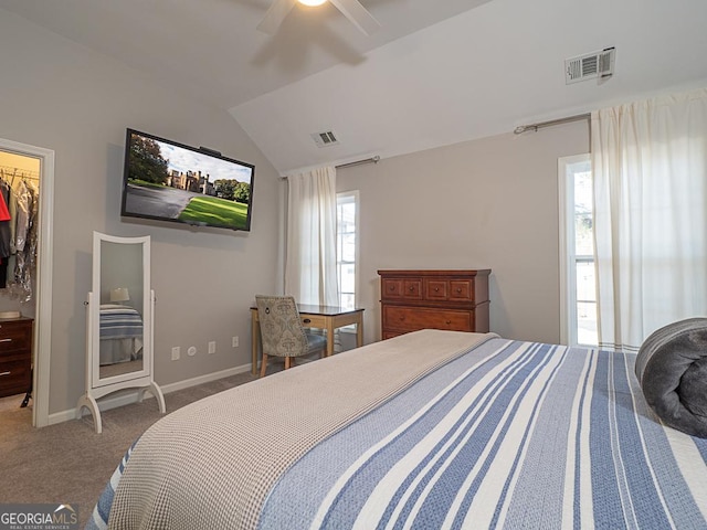 bedroom featuring vaulted ceiling, a closet, ceiling fan, a spacious closet, and carpet flooring