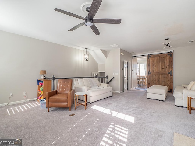 carpeted bedroom with ceiling fan and a barn door