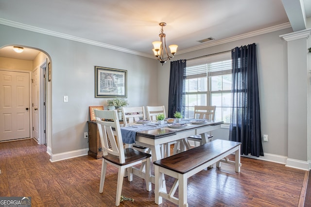 dining area with an inviting chandelier, crown molding, and dark hardwood / wood-style floors