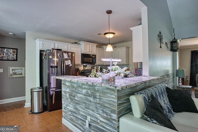 kitchen featuring stainless steel appliances, kitchen peninsula, light stone counters, white cabinetry, and decorative light fixtures