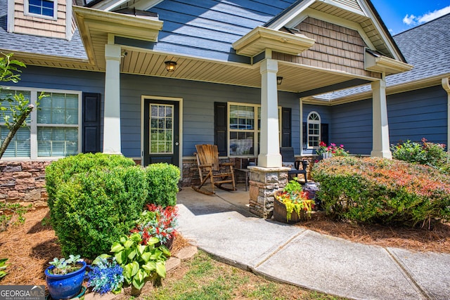 view of exterior entry with a porch