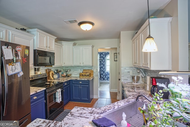 kitchen featuring stainless steel appliances, blue cabinetry, light tile patterned floors, pendant lighting, and white cabinets