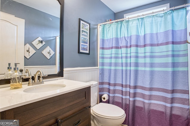 bathroom featuring vanity and toilet