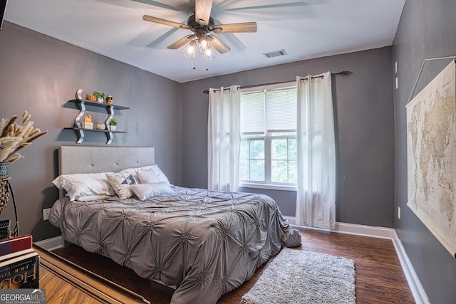 bedroom with ceiling fan and dark hardwood / wood-style floors