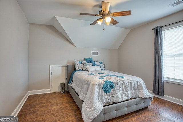 bedroom with dark hardwood / wood-style flooring, ceiling fan, and vaulted ceiling