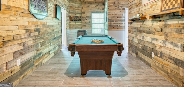 playroom with pool table, hardwood / wood-style flooring, and wood walls