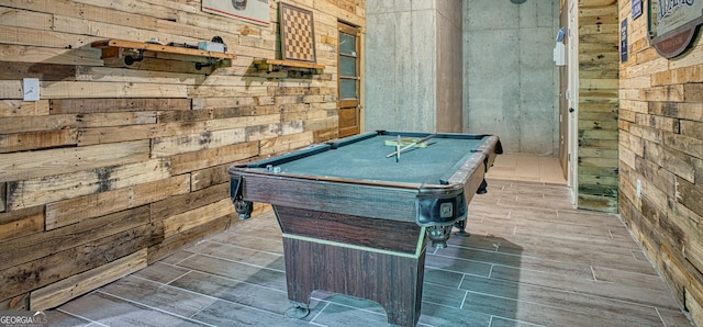 rec room with billiards and wood walls