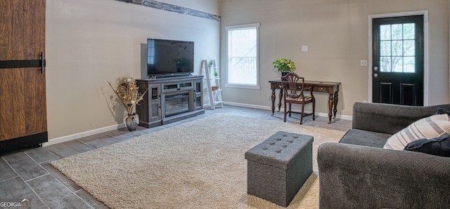 living room with a fireplace and plenty of natural light