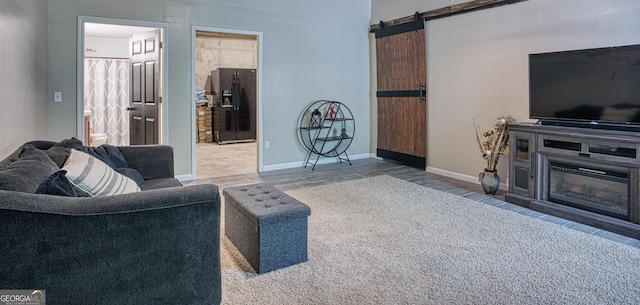 living room with a barn door and hardwood / wood-style flooring