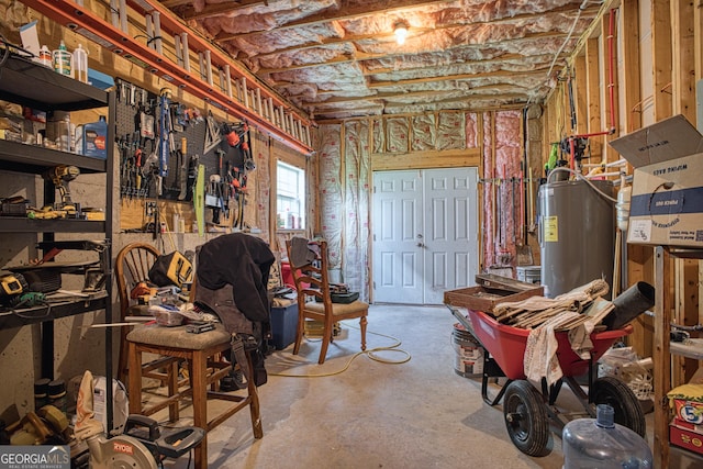 basement with a workshop area and water heater