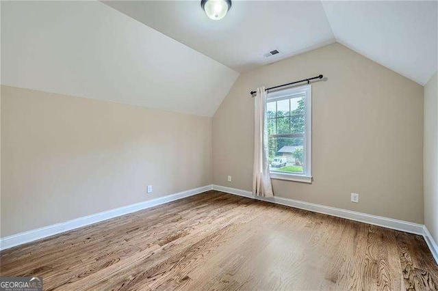 bonus room featuring lofted ceiling and hardwood / wood-style floors