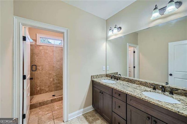 bathroom with tiled shower and vanity