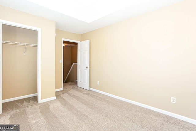 unfurnished bedroom featuring a closet and carpet