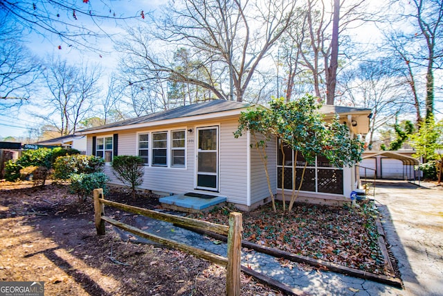 ranch-style home featuring an outbuilding and a garage