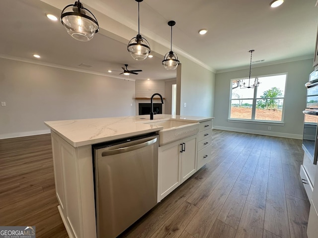 kitchen with stainless steel dishwasher, crown molding, dark wood-style flooring, white cabinets, and a sink