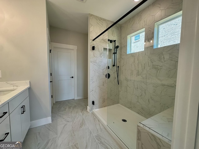 bathroom with a walk in shower, baseboards, marble finish floor, and vanity