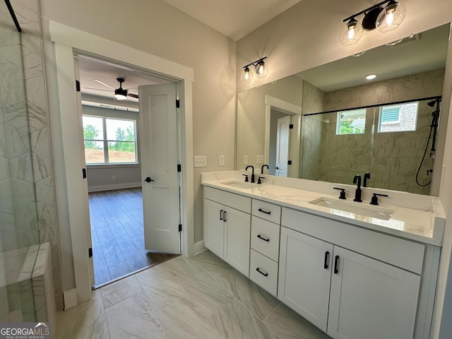 bathroom with a sink, marble finish floor, a ceiling fan, and a shower stall