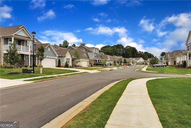 view of street with street lights, a residential view, sidewalks, and curbs