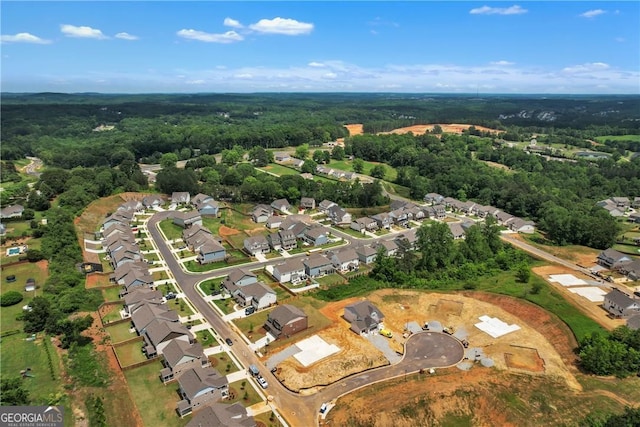 drone / aerial view featuring a view of trees and a residential view
