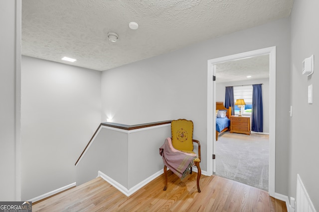 sitting room featuring a textured ceiling and hardwood / wood-style flooring