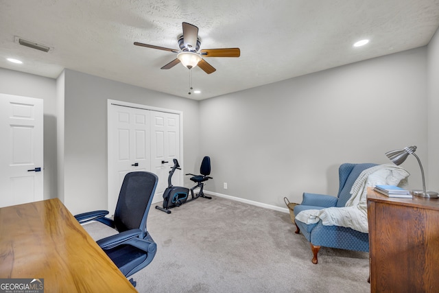 office space featuring a textured ceiling, ceiling fan, and carpet floors