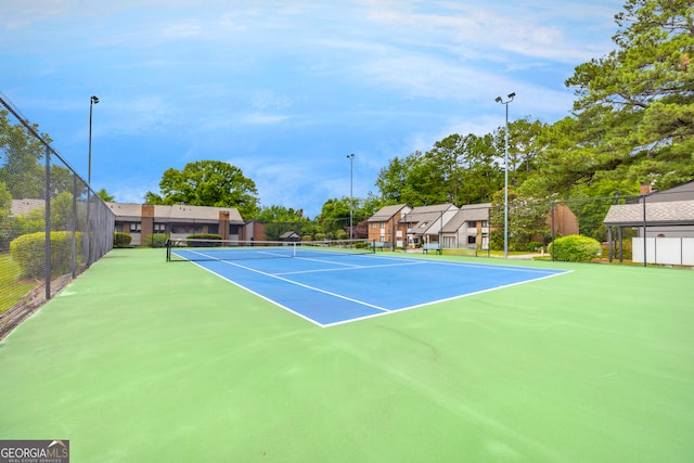 view of tennis court featuring basketball court