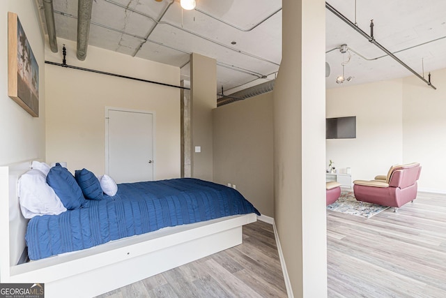 bedroom with hardwood / wood-style flooring