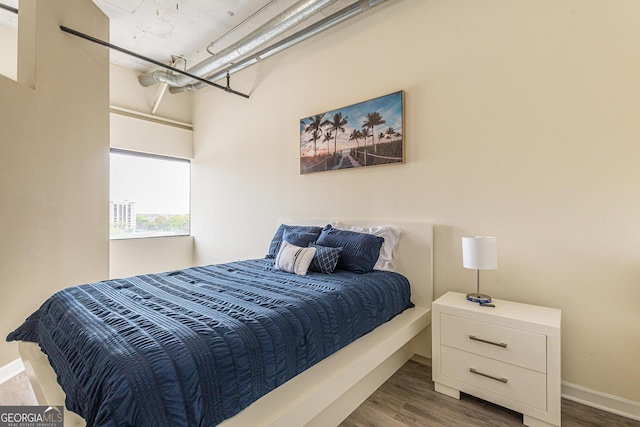 bedroom with dark wood-type flooring