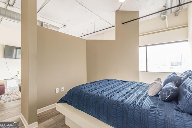 bedroom with hardwood / wood-style flooring